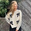 Pull ecru zwart met strikjes