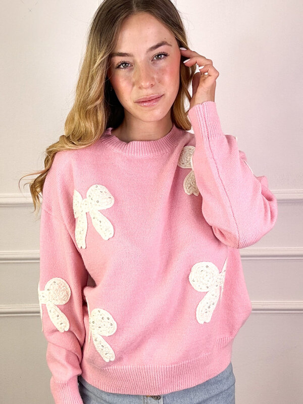 Pull met strikjes in roze